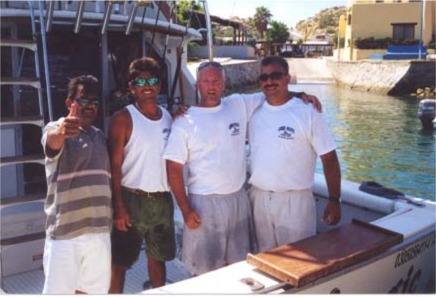 Captain Hector, Lucas, Jerry Nacey and Danny Delgado posing for a group hug after a great day aboard CABO MAGIC