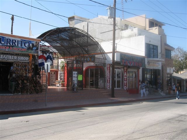 Between the Leather Shop, and the Tattoo Shop, you will see a wrought iron archway leading to a small plaza. Go upstairs and you will find our new location!