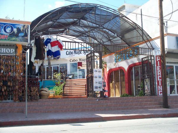Between the Leather Shop, and the Tattoo Shop, you will see a wrought iron archway leading to a small plaza. Go upstairs and you will find our new location!
